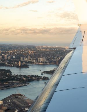 plane flying over sydney harbour
