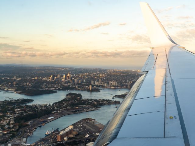 plane flying over sydney harbour