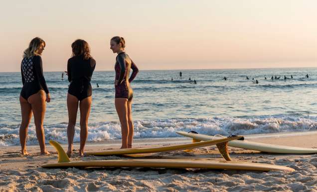 Women heading out for a morning surf at Cabarita Beach, a place on the tweed which was named in Expedia's Destinations Of The Year 2027