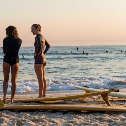 Women heading out for a morning surf at Cabarita Beach, a place on the tweed which was named in Expedia's Destinations Of The Year 2027