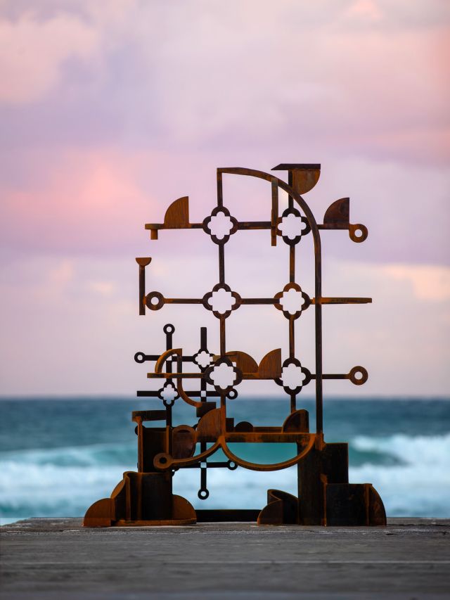David Horton’s rust-coloured lattice sculpture Peace against a pink sky at Sculpture by the Sea, Bondi