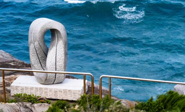 Keizo Ushio’s white looped stone sculpture Oushi Zokei - Enmusubi II beside the sea on the Bondi to Tamarama coastal walk