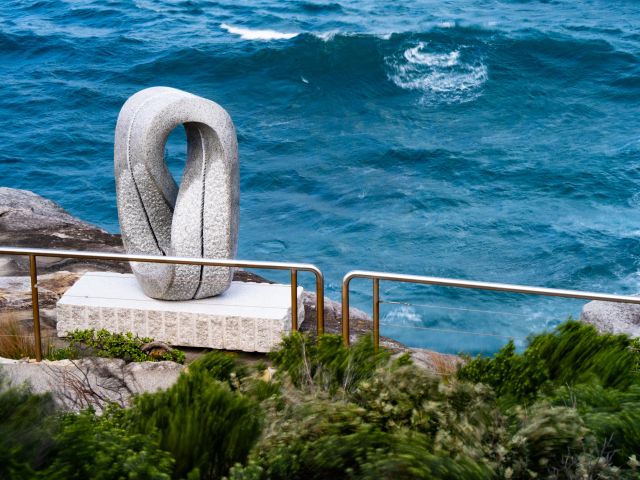 Keizo Ushio’s white looped stone sculpture Oushi Zokei - Enmusubi II beside the sea on the Bondi to Tamarama coastal walk