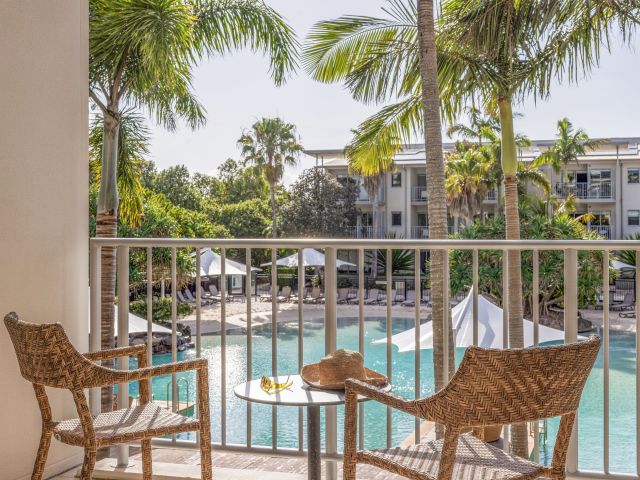 A private balcony overlooking the resort pool.