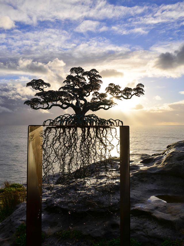 Ulan & Rachel’s sculpture The Guardians, a tree with exposed roots inside a frame, on the Bondi to Tamarama coastal walk