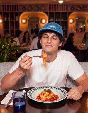 A man enjoying his pasta.