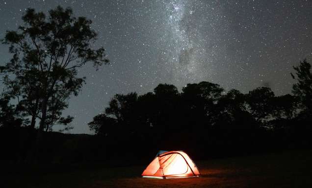 tent below a sky of stars