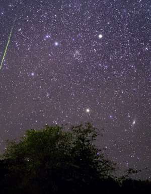 Bright meteor streaking across the night sky above Payson, Arizona during the Leonids meteor shower