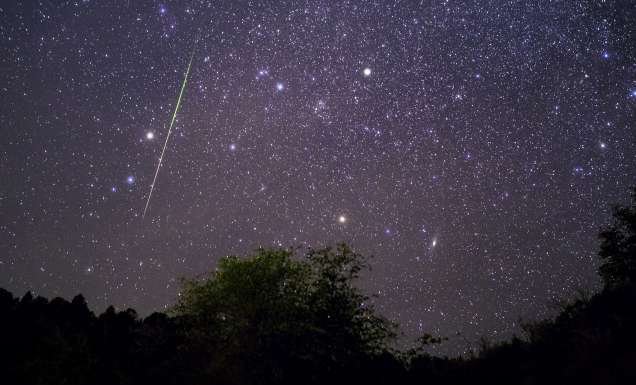 Bright meteor streaking across the night sky above Payson, Arizona during the Leonids meteor shower