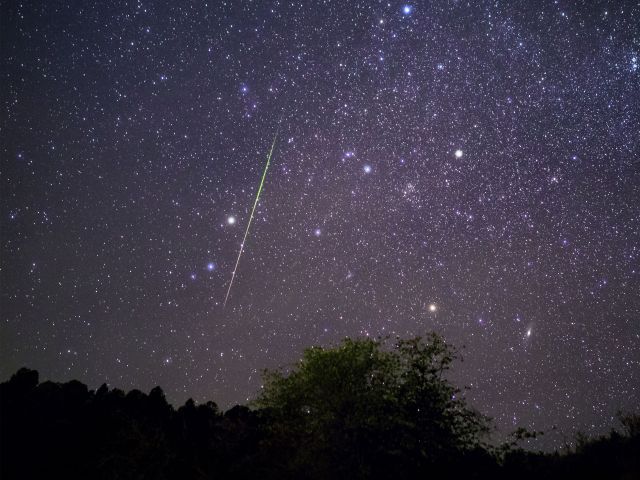 Bright meteor streaking across the night sky above Payson, Arizona during the Leonids meteor shower